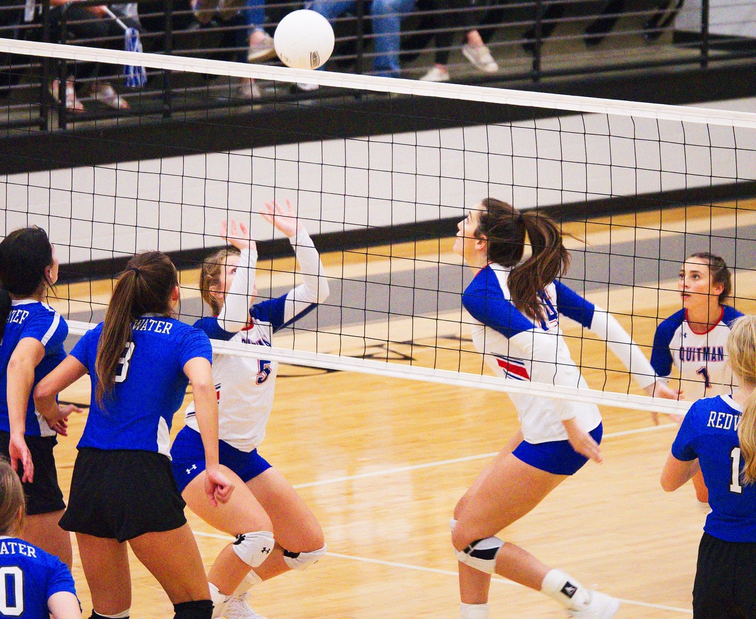 Carley Spears sets the ball for Ava Burroughs to spike it back to Redwater. [See the entire set of photos.]